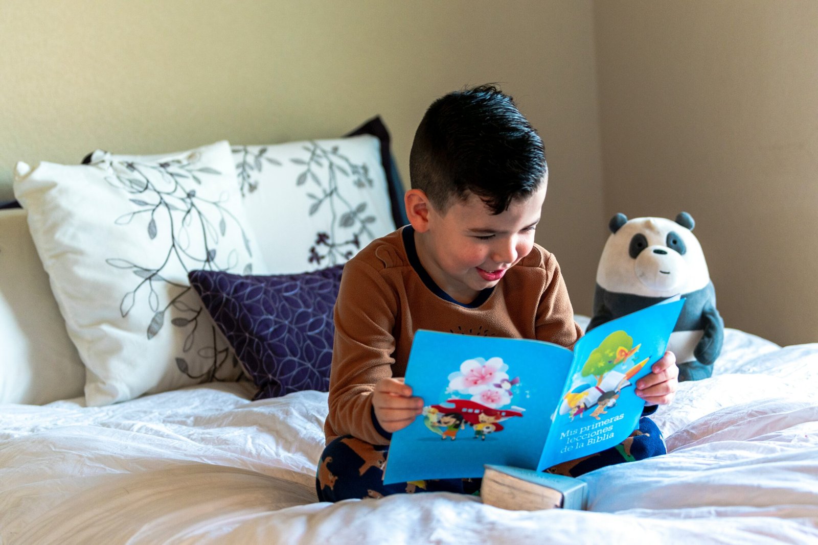 child reading coloured paper book