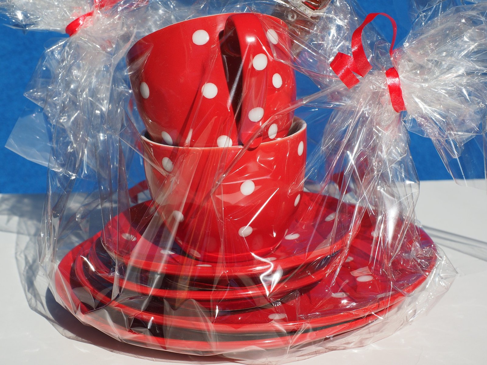 clear coloured cellophane around a crockery set